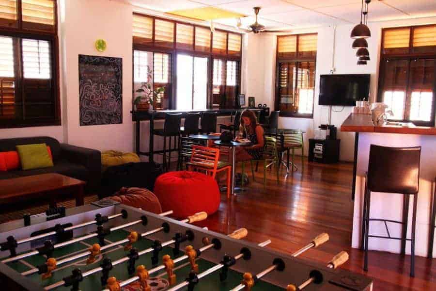 A table football setup and a seating area at Syok Hostel, Georgetown, Penang