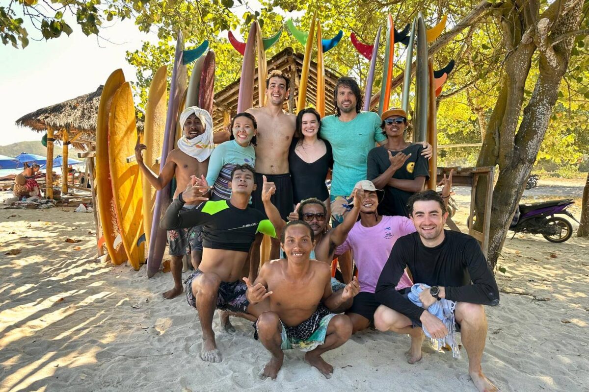Group of people on beach with surfboards